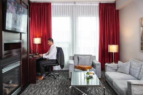 a man sitting at a desk in a hotel room at Matrix Hotel in Edmonton