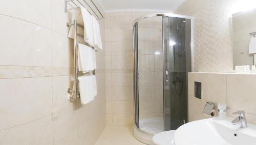 a bathroom with a shower and a sink at Petros Hotel in Bukovel