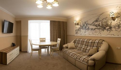 a living room with a couch and a table at Petros Hotel in Bukovel