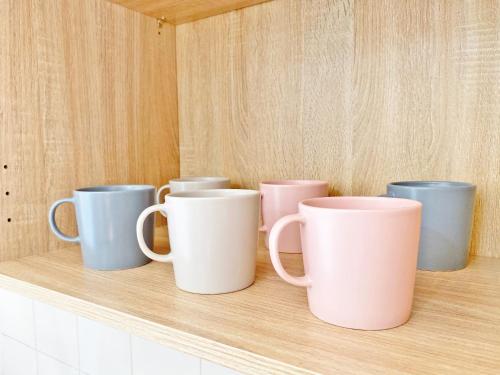 a row of coffee mugs sitting on a shelf at Giannì Holiday Home - Vesuvio/Pompei in Terzigno