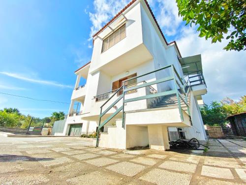 a white house with stairs in front of it at Giannì Holiday Home - Vesuvio/Pompei in Terzigno