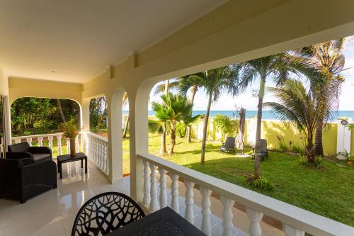 a house with a balcony with a view of the ocean at Villa Bella in Mahe