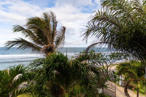 a view of a beach with palm trees and the ocean at Villa Bella in Mahe