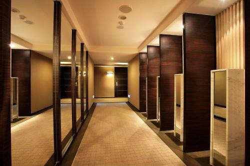 a hallway of elevators in a hotel with wooden doors at SOL Hotel in Hsinchu City