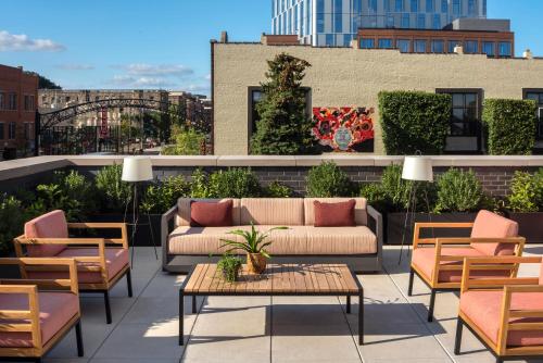 a rooftop patio with couches and tables and chairs at Graduate Columbus in Columbus