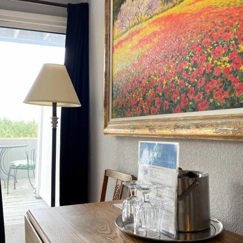 a table with a picture of a flower painting at Susitna Place B&B in Anchorage