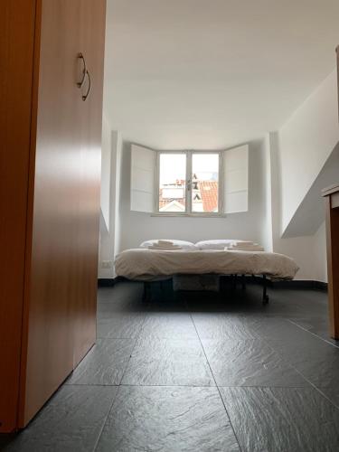 a bed in a room with a window at Mansarda Garibaldi 11 in Turin