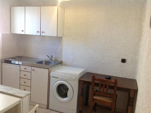 a kitchen with a washing machine and a sink at Aialion studios & apartments - Steve Apartments in Rhodes Town