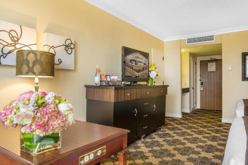 a hotel room with a table with flowers on it at Omni Houston Hotel in Houston