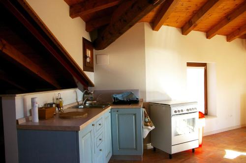 a kitchen with a sink and a stove at Agriturismo Cervano in Toscolano Maderno