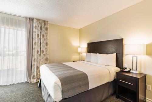 a hotel room with a bed and a window at Chase Suite El Paso in El Paso
