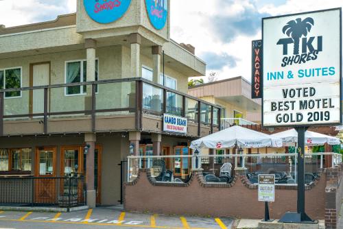 a building with a sign in front of it at Tiki Shores Inn & Suites in Penticton