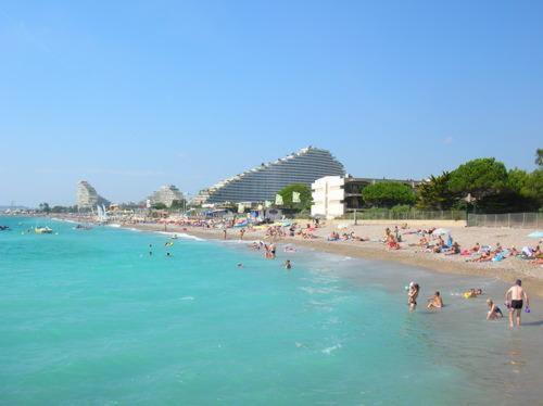 a group of people in the water at a beach at Lovely apartment in Marina Baie des Anges- Baronnet - Sew view, free parking spaces on site, restaurants, beach, supermarket in Villeneuve-Loubet
