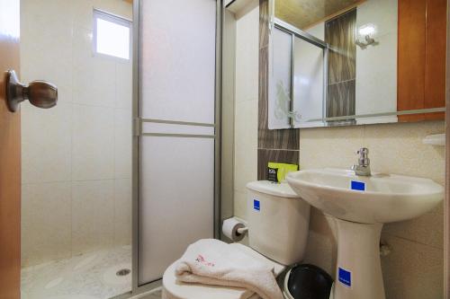 y baño con ducha, aseo y lavamanos. en Hotel El Rubí, en Bucaramanga