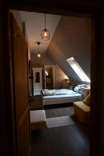 a attic room with two beds and a window at Tulipán Villa Panzió in Szolnok