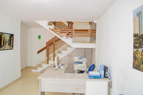 an office with a staircase and a desk in a room at Hotel Ocean View in Cartagena de Indias