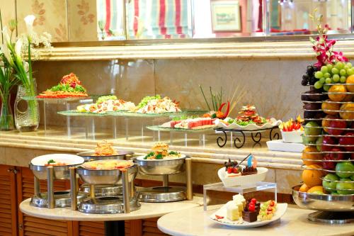 a buffet line with different types of food on plates at Ambhara Hotel in Jakarta