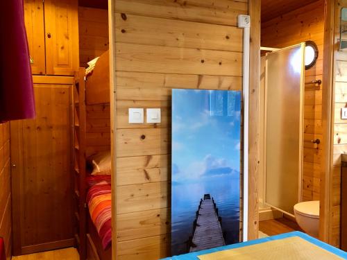 a room with a door with a picture of a pier at Millygite roulotte - 4 seasons Chalet-on-wheels in Milly-la-Forêt