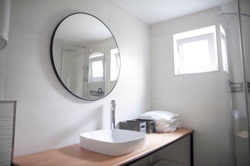 a bathroom with a sink and a mirror on a counter at Little house - Hiška in Izola