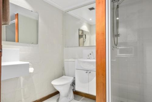a white bathroom with a toilet and a sink at Balmoral On York in Launceston