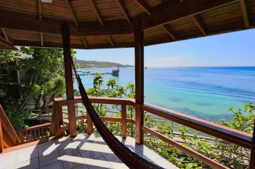 a hammock on a porch overlooking the ocean at Fosters West Bay Resort in West Bay