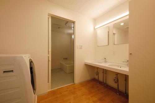 a bathroom with a sink and a mirror at 渚泊魚津丸 in Motoshin