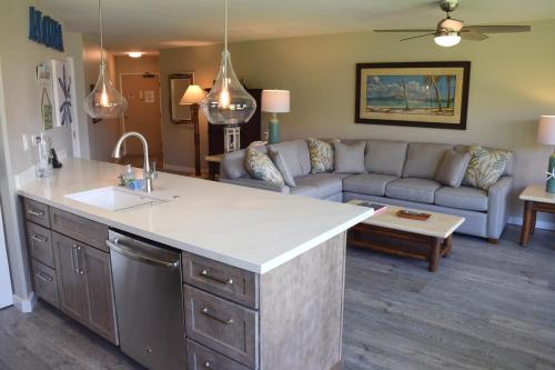 a kitchen and living room with a couch and a kitchen island at Maui Sunset B215 in Kihei