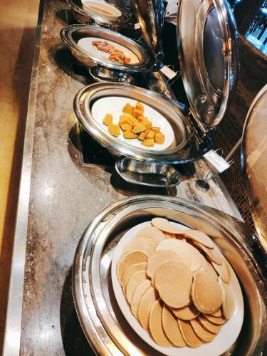 a bunch of plates of food on a counter at Sabah Oriental Hotel in Kota Kinabalu