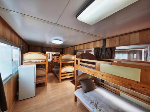 a room with a bunk bed and a dorm room at Hotel Hamby Resort in Chatan