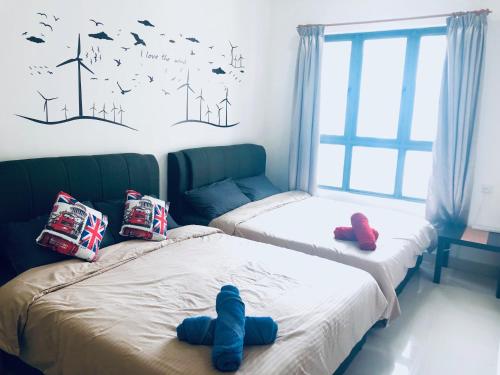Un pat sau paturi într-o cameră la CozySoho-Cyberjaya,Netflix provided,fit 5pax