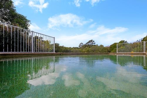 a pool of water with a gate in a park at Valley View Bed and Breakfast in Newcastle
