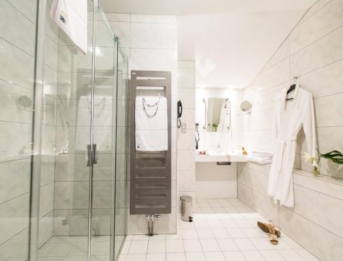 a bathroom with a shower with a glass door at Hôtel Spa Marotte in Amiens