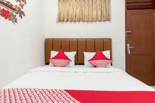 Una cama o camas en una habitación de SUPER OYO 356 Titipapan Residence