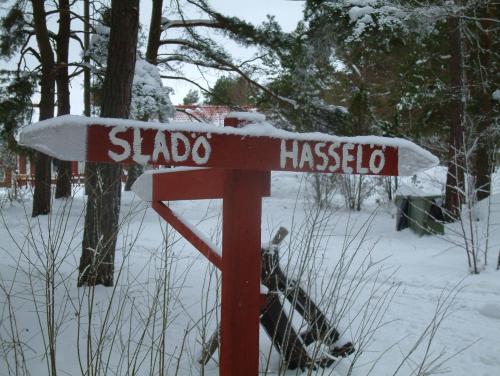 a red street sign with snow on top of it at Hasselö Hostel in Hasselö