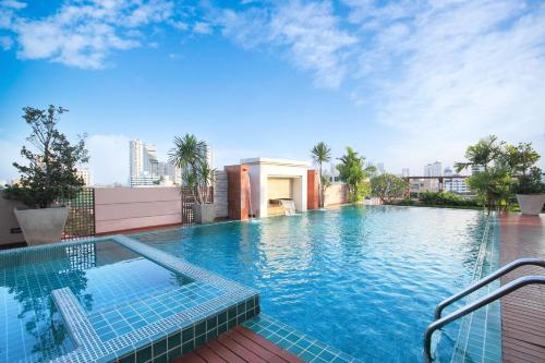 a large swimming pool on top of a building at D Varee Montara Thonglor 25 in Bangkok
