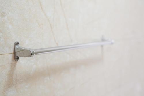 a metal towel rack on the wall of a shower at Apatel The Mansion Jasmine Tower Aurora J31J in Jakarta