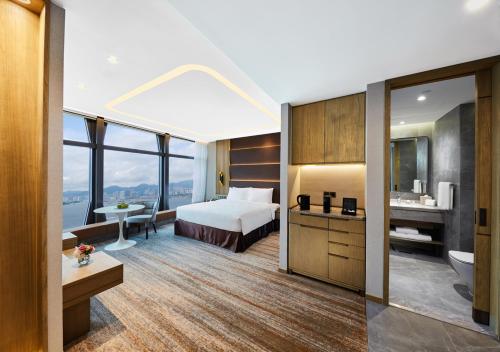 a hotel room with a bed and a bathroom at Oasis Aurum 181 Hotel in Hong Kong