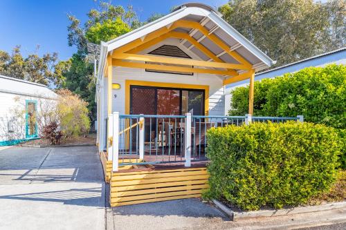 a tiny house with a porch and a gate at Ingenia Holidays South West Rocks in South West Rocks