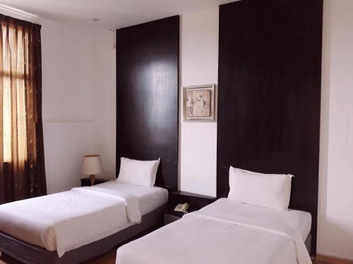 Postel nebo postele na pokoji v ubytování Ginasuite Kompleks27 Hotel