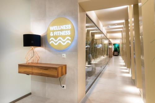 a hallway with a wellness and fitness sign on a wall at Hotel Cristal Białystok in Białystok