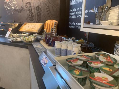 a kitchen with food on a counter in a kitchen at Hotel Stadt Cuxhaven in Cuxhaven