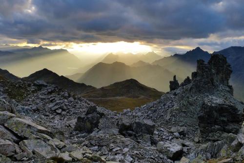 a view from the top of a mountain with the sun setting at Appartements Künk in Schruns-Tschagguns