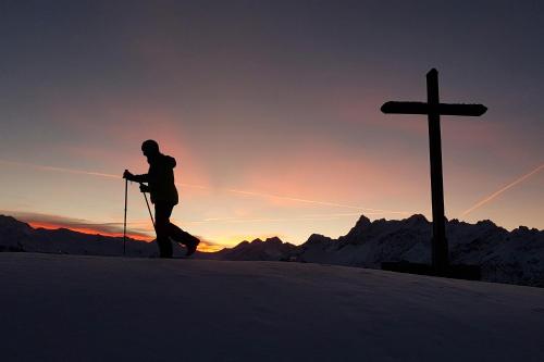 a person on skis next to a cross at Appartements Künk in Schruns-Tschagguns