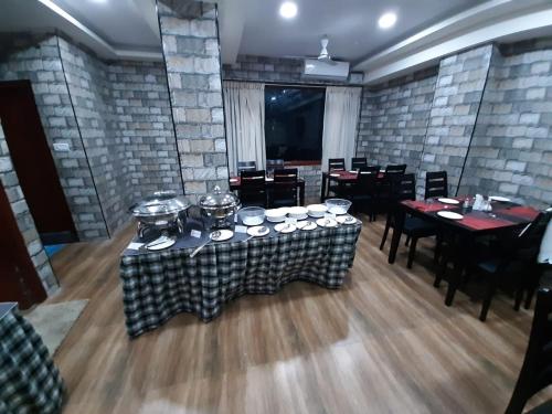 a dining room with tables and chairs and brick walls at BAY INN in Chennai