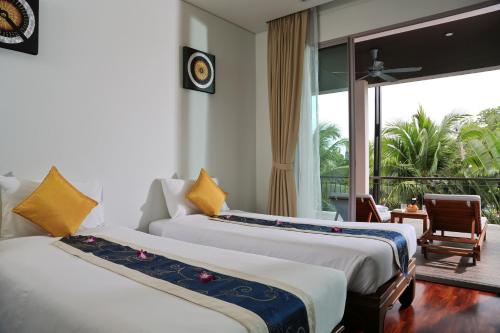 two beds in a hotel room with a balcony at Kata gardens luxury 2bedroom 4B Near Kata Noi Beach in Kata Beach