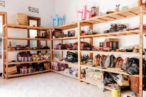 a room with wooden shelves filled with items at Griya Erlangga Homestay in Yogyakarta