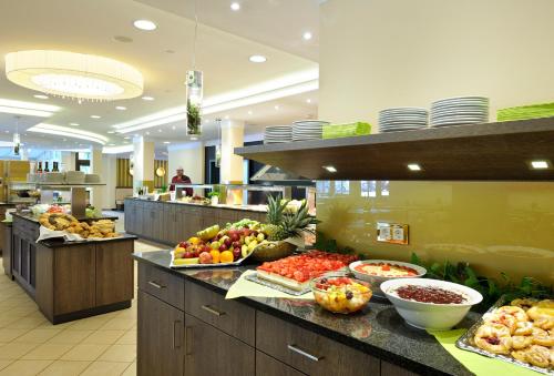 a buffet line with many different types of food at Johannesbad Hotel Königshof in Bad Füssing