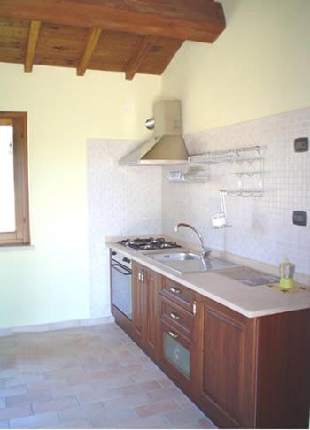 a kitchen with a sink and a stove at Residence Albornoz in Piediluco