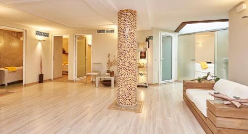 a living room with a couch and a large column at Hotel Grèvol Spa in Camprodon