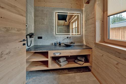a bathroom with a sink and a mirror at Zugspitz Lodge in Ehrwald